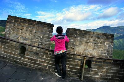 Silhouette of woman standing against wall