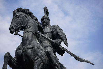 Low angle view of statue against sky