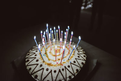 Close-up of cake lit with candles
