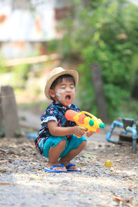 Lovely thai boy aged 1 year 11 months playing water gun songkran festival in thailand.