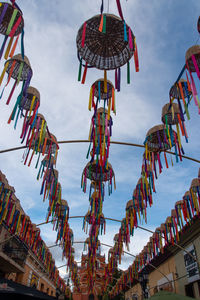 Low angle view of flags hanging against sky