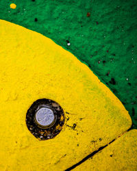 High angle view of water drops on yellow leaf