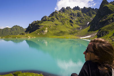 Portrait of woman by lake against sky