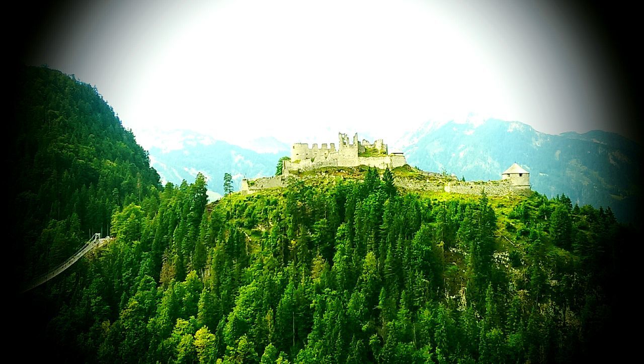 green color, sky, mountain, beauty in nature, nature, growth, tranquility, tranquil scene, panoramic, sunlight, built structure, scenics, building exterior, landscape, plant, architecture, outdoors, day, field, no people