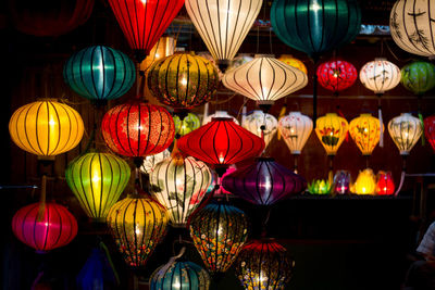 Illuminated lanterns hanging for sale in store