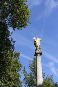 Back of the gilt statue of saint paul at the top of st paul's cross in the cathedral precinct 