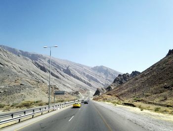 Cars on country road towards mountains