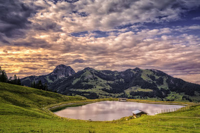 Scenic view of lake and mountains against sky