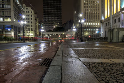 Iluminated city street of the cha viaduct bike path during rainy season at night