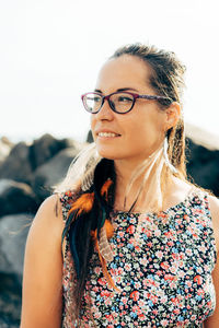 Woman looking away while standing outdoors