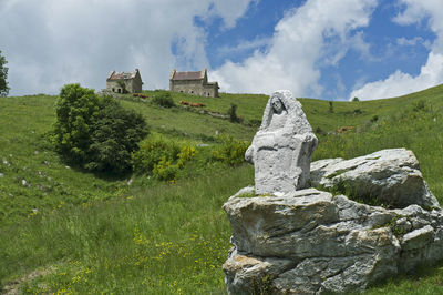 Panoramic view of rocks on field against sky