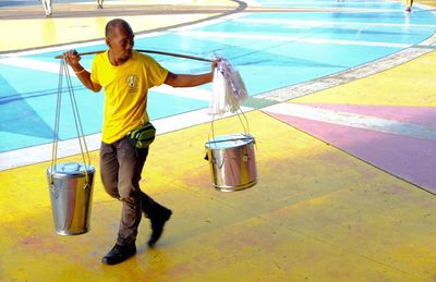 Full length of man standing on yellow water