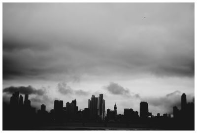 City skyline against cloudy sky