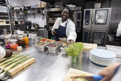Chef smiling while working in kitchen of restaurant