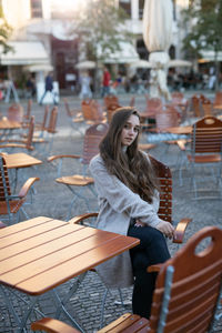 Portrait of young woman sitting on chair