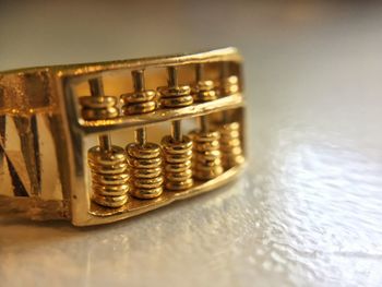 Close-up of coins metal equipment on table
