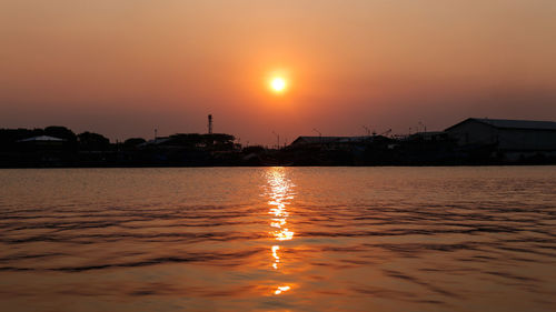 Scenic view of sea against orange sky