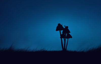 Silhouette landscape against blue sky