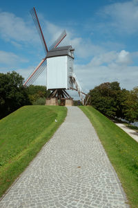 View of windmill on landscape against sky