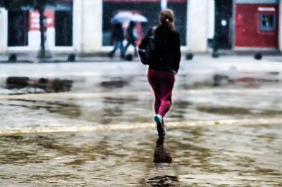 Rear view of man walking in winter