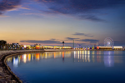 Illuminated city at waterfront