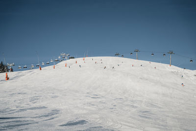 Skiers on piste during covid pandemic in zell am see, austria.