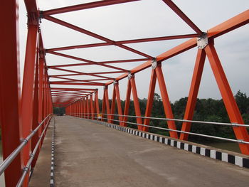 Footbridge against sky in city