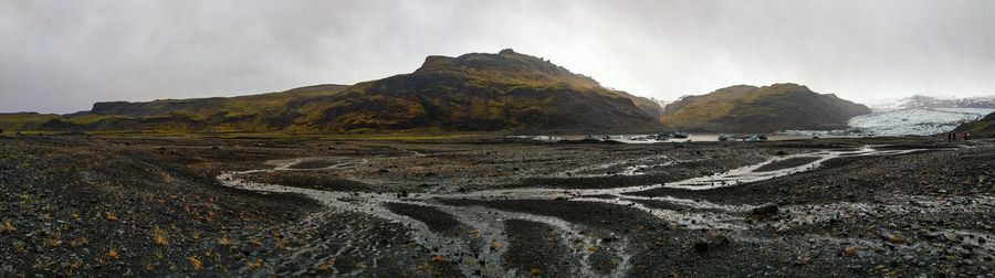 Scenic view of sea and mountains against sky