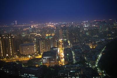 Aerial view of city lit up at night