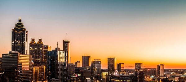 Cityscape against sky at sunset