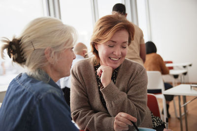 Businesswomen sitting together in business seminar