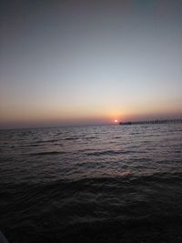 Scenic view of sea against clear sky during sunset