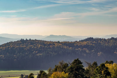 Scenic view of trees and mountains against sky