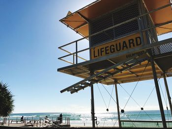 Lifeguard hut on beach against clear sky