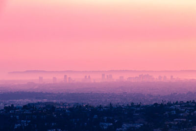 Aerial view of townscape against sky during sunset