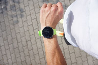 High angle  of man with his running watches 