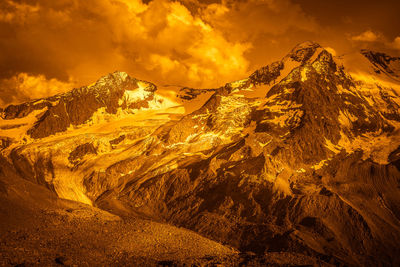 Fantasy golden color image of glaciers at the foot of the palla bianca peak