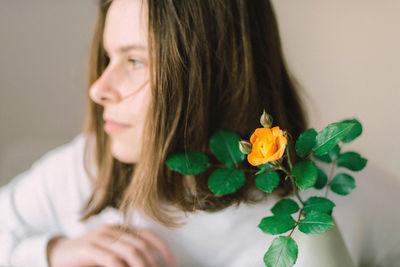 Portrait of woman with red flower