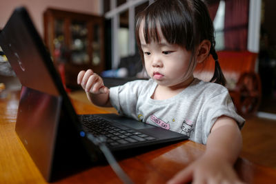 Girl using laptop on table