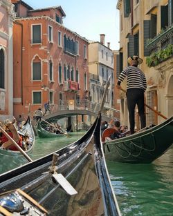 People traveling by gondolas in canal