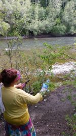 Woman standing by river