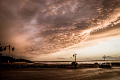 Road against dramatic sky during sunset