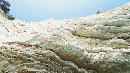 Low angle view of rock formation against sky