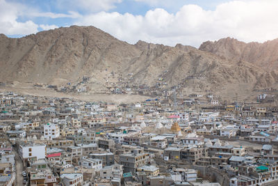 High angle view of townscape and mountains against sky