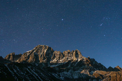 Scenic view of mountains against clear sky at night