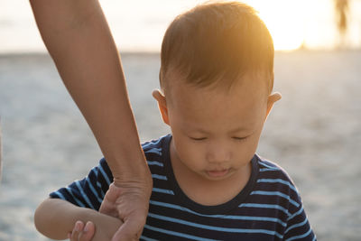 Low angle view of boy against sea