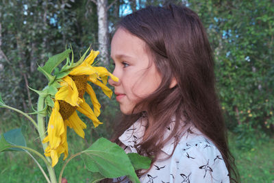 Portrait of woman with yellow flower