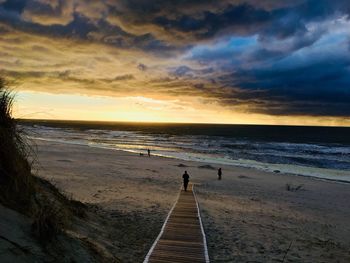 Scenic view of beach against sky during sunset