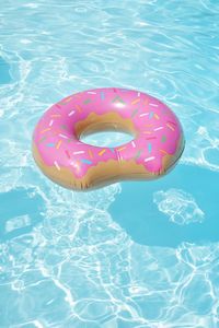 High angle view of pink floating on swimming pool