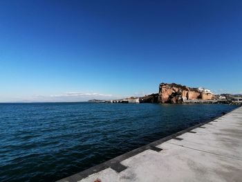 Scenic view of sea against clear blue sky